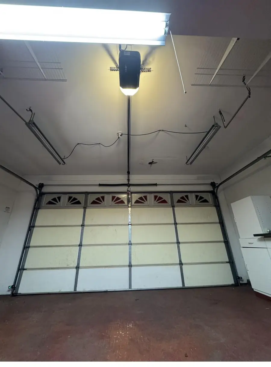 Insulated garage door with window panels, seen from inside the garage
