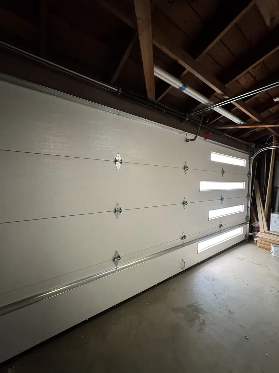 New garage door with window lites, seen from inside after installation