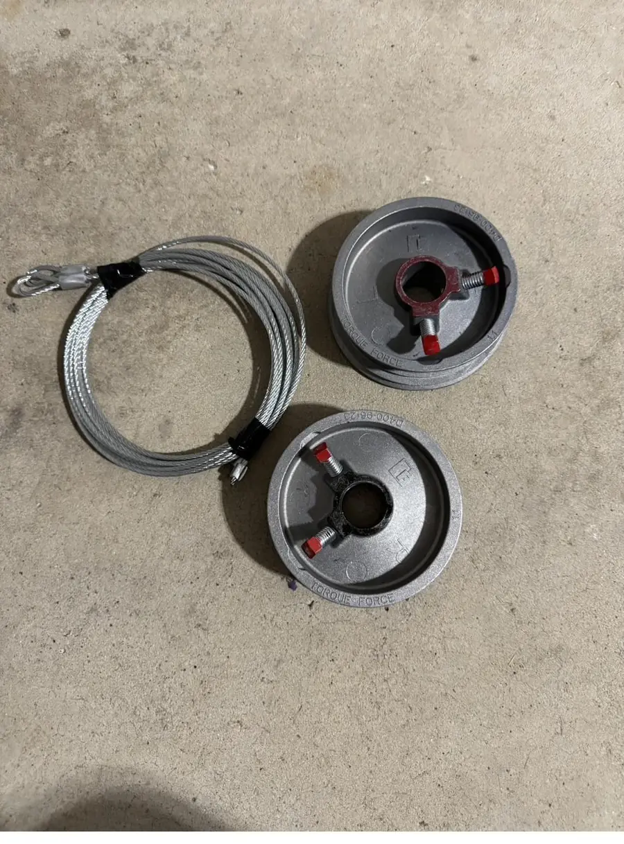 Cable drums and lift cables replaced during a garage door tune-up